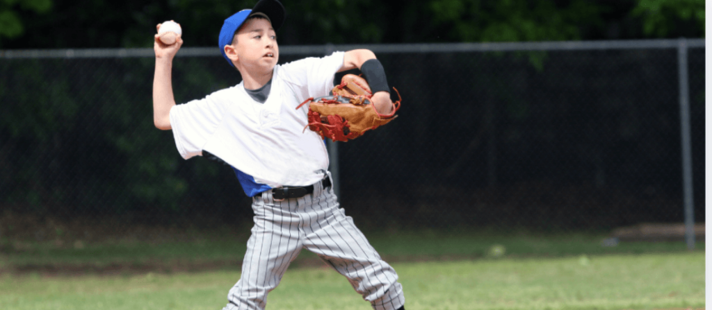 young boy throwing a baseball