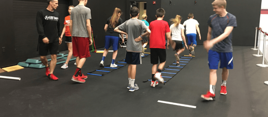 youth athletes learn body control with agility ladder.
