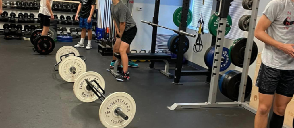 youth boys lifting weights