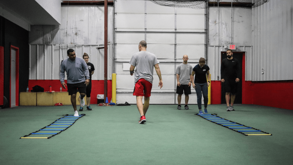 coaches performing agility stiffness drills