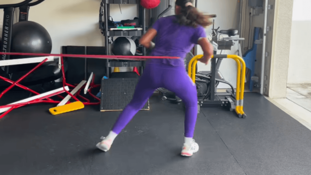 athlete performing lateral run with resisted band
